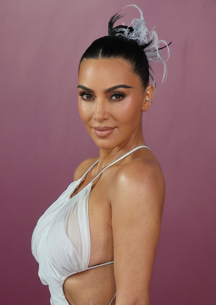 Kim Kardashian wearing a feather updo and white chiffon dress